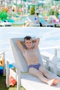 Young boy in a swimsuit on a shelf by the pool Royalty Free Stock Photo