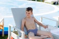 Young boy in a swimsuit on a shelf by the pool Royalty Free Stock Photo
