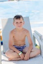 Young boy in a swimsuit on a shelf by the pool Royalty Free Stock Photo