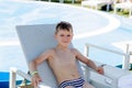 Young boy in a swimsuit on a shelf by the pool Royalty Free Stock Photo