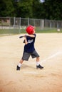 Young Boy Swinging Baseball Bat at Ball in Youth Ragball Game Royalty Free Stock Photo