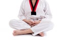 Young boy in taekwondo uniform doing meditation Royalty Free Stock Photo