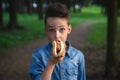 A young boy takes a bite of a hot dog Royalty Free Stock Photo