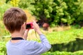 Young boy taking photos of the pond Royalty Free Stock Photo