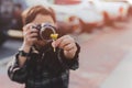Young boy taking photos of yellow flower in his hand on vacation in Cinematic color. Royalty Free Stock Photo