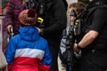 Young boy talking and looking at armed police during tour de yorkshire