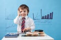 Young boy, talking on the phone, writing notes, money and tablet Royalty Free Stock Photo