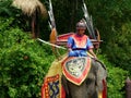 Young Boy in Thai Ancient Costumes riding an Elephant