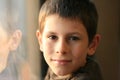 Young boy in thought with window reflection Royalty Free Stock Photo