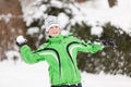 Young boy throwing snowballs