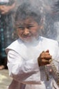 A young boy thurifer in guatemala