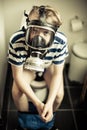 Young boy on toilet wearing gas mask Royalty Free Stock Photo