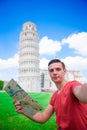 Young boy with toristic map on travel to Pisa. Tourist traveling visiting The Leaning Tower of Pisa. Royalty Free Stock Photo