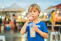 Young boy tourist on Walking street Asian food market