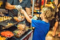 Young boy tourist on Walking street Asian food market