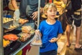 Young boy tourist on Walking street Asian food market