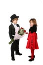 Young boy in tuxedo giving girl roses