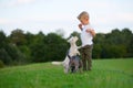 Young boy with two terrier hybrid dogs outdoors Royalty Free Stock Photo
