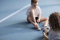 Young boy tying sport shoes