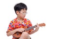 Young boy with ukulele over white Royalty Free Stock Photo