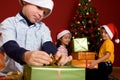 Young boy unwrapping Christmas gift