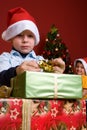 Young boy unwrapping Christmas gift Royalty Free Stock Photo