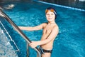 Young boy using ladder to exit swimming pool Royalty Free Stock Photo