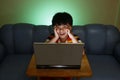 Young boy using a laptop computer and smiling Royalty Free Stock Photo