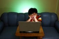 Young boy using a laptop computer and smiling Royalty Free Stock Photo