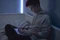 Young boy using laptop in his room Royalty Free Stock Photo