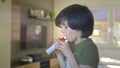 Young boy using Spirometer, Measuring Lung Capacity and Force Expiratory Volume.