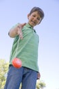 Young boy using yo yo outdoors smiling