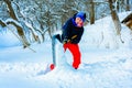 A young boy in the village cleans the snow and makes a walk Royalty Free Stock Photo