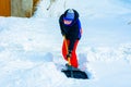 A young boy in the village cleans the snow and makes a walk Royalty Free Stock Photo