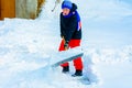 A young boy in the village cleans the snow and makes a walk Royalty Free Stock Photo
