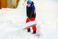 A young boy in the village cleans the snow and makes a walk Royalty Free Stock Photo