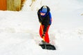 A young boy in the village cleans the snow and makes a walk Royalty Free Stock Photo