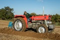 Young boy with vintage red tractor ploughing Royalty Free Stock Photo