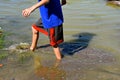 Young boy wading in swampy mud Royalty Free Stock Photo