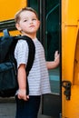 Young boy waits to board bus for school Royalty Free Stock Photo