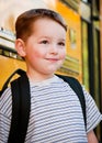 Young boy waits to board bus for school Royalty Free Stock Photo