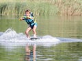 Young boy wakeboarding