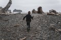 Young boy walking onto Rialto Beach in Olympic National Park