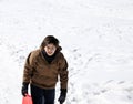 Young boy walks with tobogganing on fresh snow in the winter Royalty Free Stock Photo