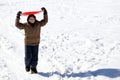 Young boy walks with tobogganing on the head on fresh snow Royalty Free Stock Photo