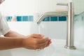 Young boy wash his hand by water from faucet Royalty Free Stock Photo