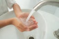 Young boy wash his hand by water from faucet Royalty Free Stock Photo