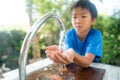 Young boy wash his hand by water from faucet Royalty Free Stock Photo