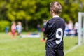 Young boy watching a kids soccer match Royalty Free Stock Photo