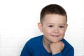 Young boy wearing blue jacket smiling looking at camera. Royalty Free Stock Photo